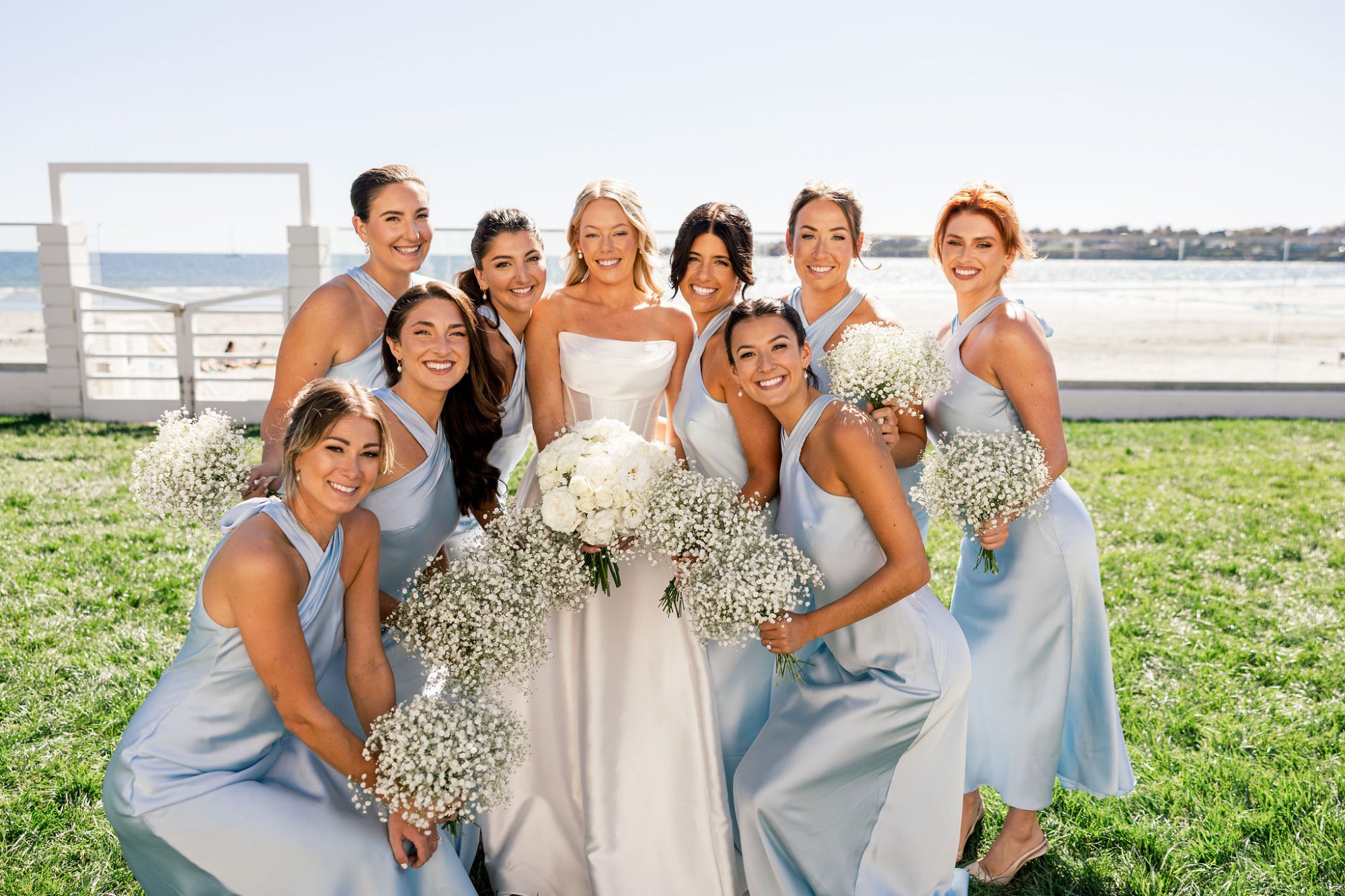Bridal party in light blue dresses with coordinated hair and makeup at CT beach wedding